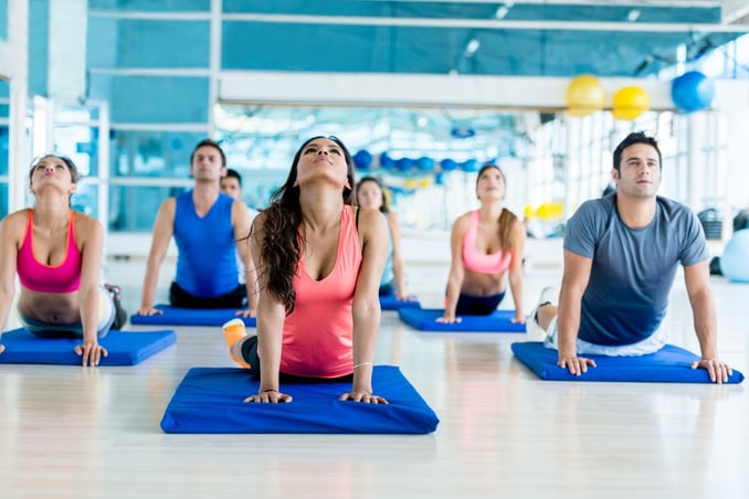 Group of people at the gym in a yoga class